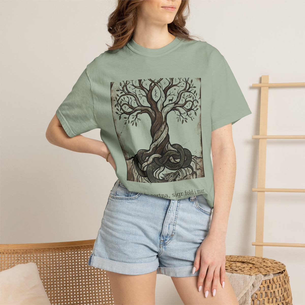 Model wearing the sage green Völuspá Yggdrasil tee by Palimpsest