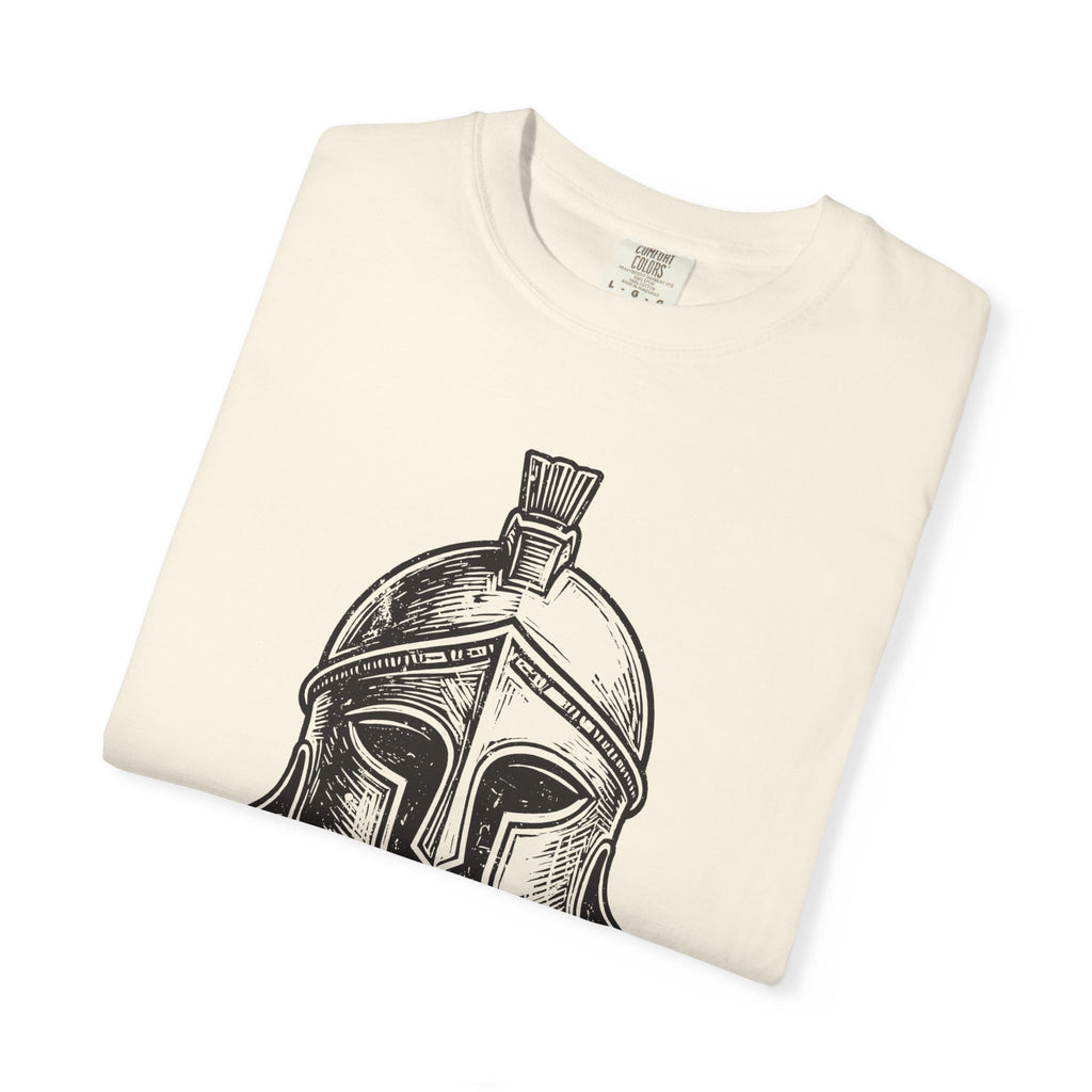 Folded cream T shirt featuring a bold black woodcut Corinthian helmet from the Iliad design on the front тарабынан