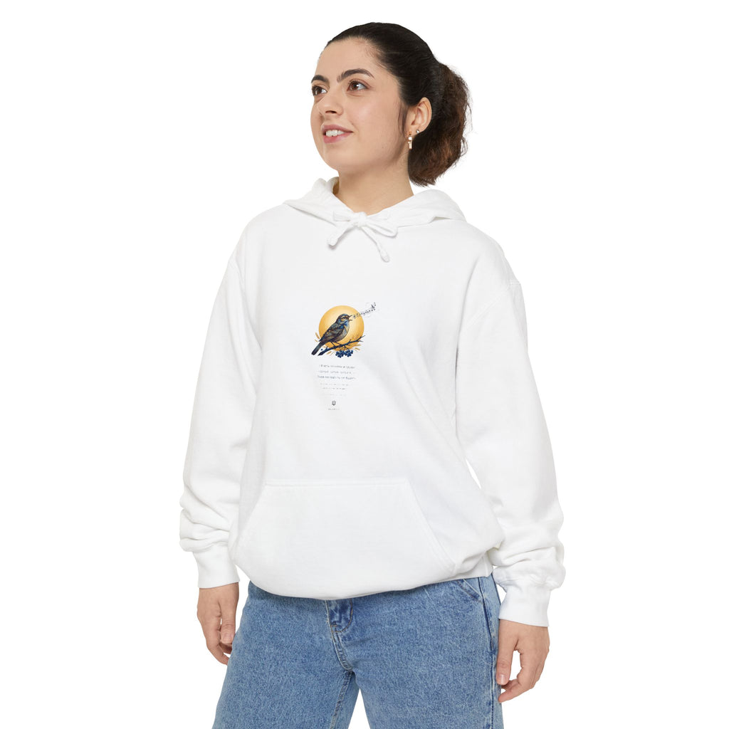 Woman wearing the white Chary Nochi hoodie — a nightingale perched against a gold moon