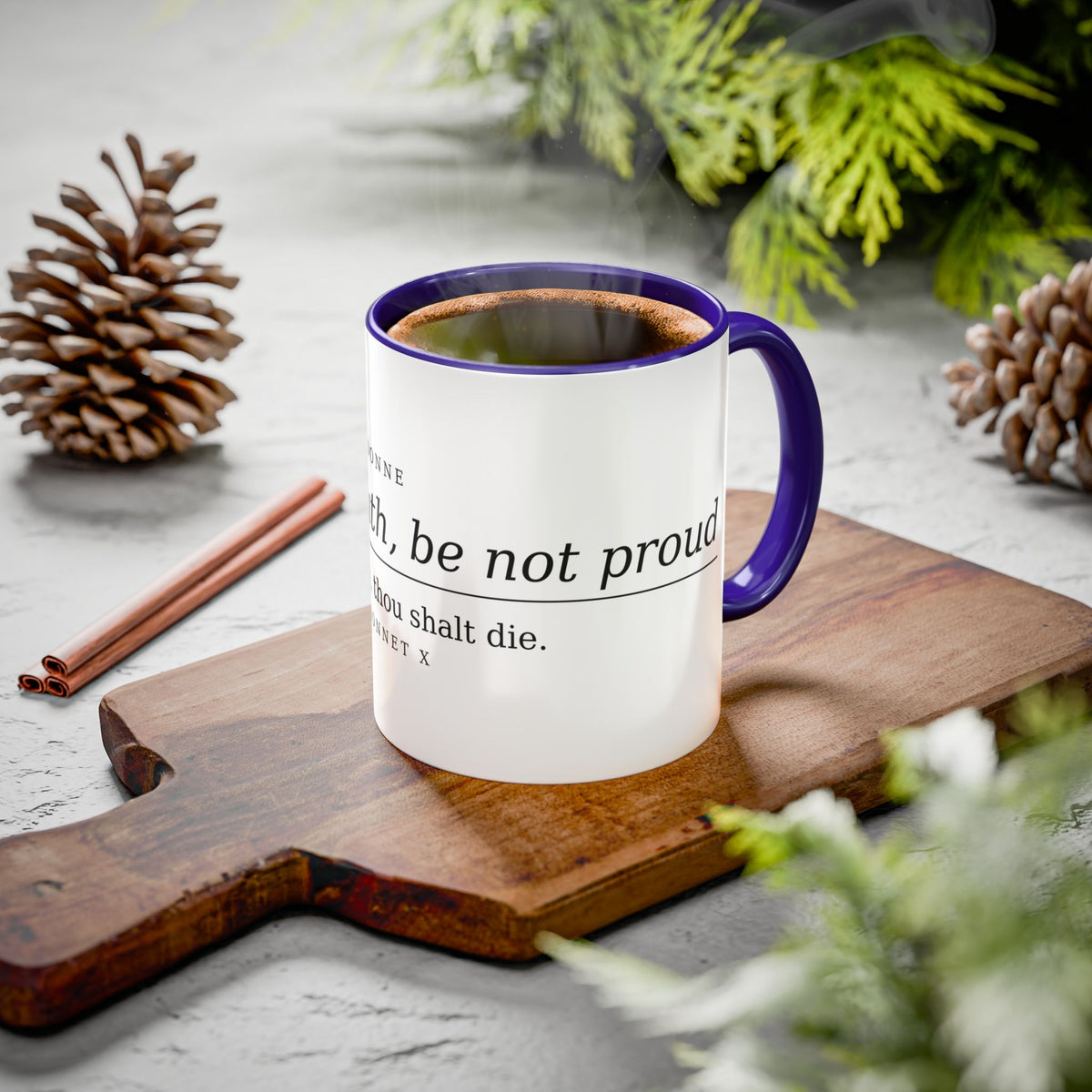 Death Be Not Proud mug with a purple handle styled on a board with pine cones and cinnamon
